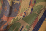 Textured Stone Wash Dhurrie detail with stylized red animal, cross motifs on pale blue bands.