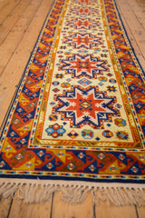 White fringe and fully secured end of the vintage Siberian Kazak runner.