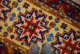 Siberian Kazak runner with saffron yellow field and geometric starburst in copper, navy, and sky blue.
