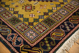 Dark blue geometric border with rust, gold, and green motifs, showing cream fringe.