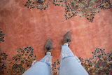 Lush, even pile of a vintage Kerman carpet's dusty rose field and detailed floral border.