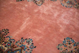 Full and even pile texture on the dusty rose field of a vintage Persian Kerman.