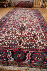 Angled shot along a Mehrivan runner showing the full pile and interconnected floral palmettes.