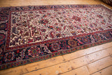 Angled view down the length of a vintage Mehrivan runner showing its allover geometric floral pattern.