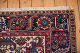 Intricate navy and red geometric border with clean ivory fringe on a vintage Mehrivan rug.