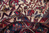 Delicate geometric relief and floral palmettes on the full pile of a vintage Persian rug.