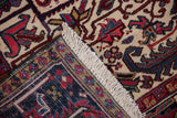 Folded corner of a vintage Mehrivan rug showing the hand-knotted back, plush pile, and ivory fringe.