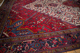 Corner view of a vintage Mehrivan carpet, showing the sapphire blue border and serrated leaf field.