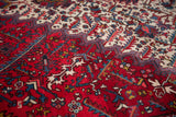 Even hand-knotted pile of a vintage Mehrivan with serrated leaves in sapphire blue and wine red.