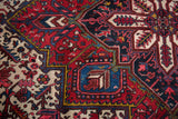 Geometric motifs with serrated leaves in sapphire blue, wine red, and gold on a vintage carpet.