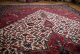Close view of the even pile and geometric lattice pattern on a vintage Persian Mehrivan rug.