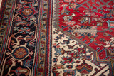 Geometric leaves, floral buds, vinery on vintage Mehrivan rug in cherry red, navy, ivory.