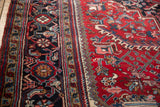 Intricate geometric border and red field with serrated leaves, vinery on a Mehrivan carpet.