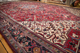 Vintage Mehrivan carpet with a prominent navy blue border and geometric field patterns.