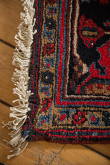 Ivory fringe, full pile, and geometric border details of a Mehrivan rug.