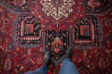 Heriz style Mehrivan rug: geometric medallion, serrated leaves, palmettes in cherry red and navy.