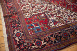 Corner detail of the Mehrivan rug's navy blue samovar turtle border and plush, hand-knotted pile.