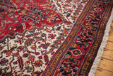 Corner detail of a vintage Mehrivan rug with its full pile and geometric samovar turtle border.