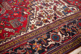 Detailed view of the vintage Mehrivan's navy blue samovar turtle border and plush cherry red field.
