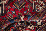 The like-new, full pile of a hand-knotted Mehrivan rug with rich red and sapphire blue tones.