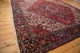 Angled view of the vintage Mehrivan carpet's plush, full pile and detailed geometric border design.