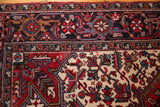 A vintage Mehrivan rug's navy border with geometric florals and serrated leaf designs.