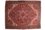Vintage Heriz carpet with a grand geometric medallion in gem-tones of ruby red, sapphire blue, and ivory.