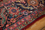 Intact ruby red side cord selvage on a vintage Heriz carpet's densely ornamented border.