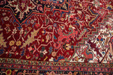 Saturated gem-tone colors in the densely ornamented wool pile of a vintage Heriz rug.
