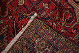 Corner detail of a fine Heriz carpet showing the plush ruby pile and hand-knotted back.