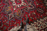 Dense, full pile and crisp geometric pattern of a red vintage Persian Mehrivan carpet.
