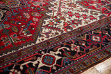 Intricate geometric borders in cherry red, navy, and ivory on a plush vintage Persian Mehrivan rug.