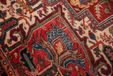 Hand-knotted detail of Vintage Heriz carpet showing quatrefoil and floral motifs in red, navy, ivory.