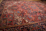 Black cherry red Heriz rug detail with sapphire blue and ivory stylized floral motifs.