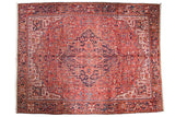 Vintage Heriz carpet, oversized diamond medallion, geometric vinery, brick red, navy blue.