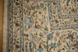Detailed hand-knotting of peacocks and pheasants in a vintage Persian Tabriz forest scene.