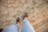 Scalloped edge and floral sprays on the powder blue and beige ground of a vintage Tabriz carpet.