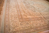 Detailed floral borders and a soft, full pile on the corner of a vintage Persian Tabriz rug.