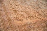 Fine floral sprays on the sand field meeting the scalloped powder blue medallion of a vintage Tabriz rug.