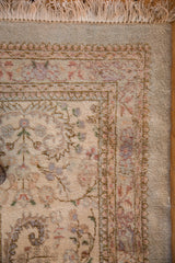 Intact ivory fringe and full pile on the corner of a vintage Persian Tabriz carpet.