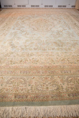 Low angle view across the full pile of a vintage Tabriz carpet's floral border.