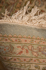 Close view of the hand-knotted weave and original ivory fringe on a vintage Persian Tabriz.