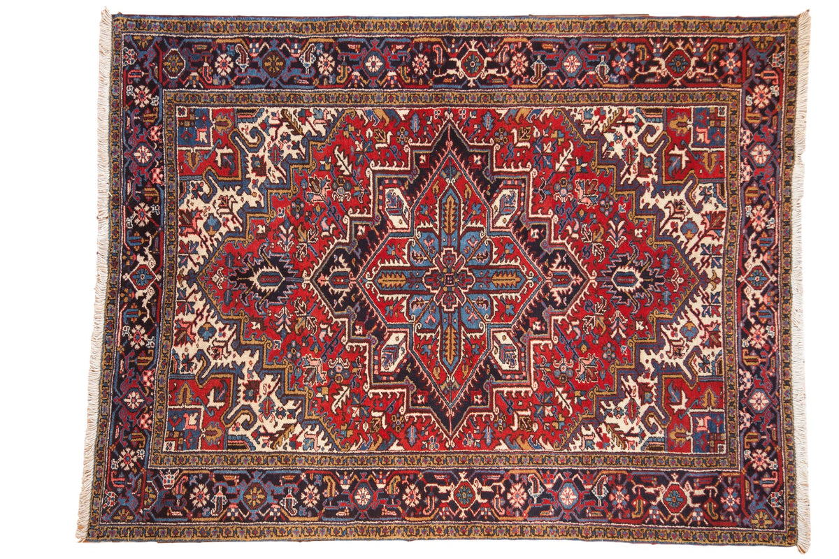 Vintage Mehrivan carpet with a quatrefoil medallion, geometric floral field in red, and a navy blue turtle border.