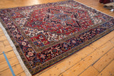 Angled perspective on a vintage Mehrivan carpet, displaying its geometric medallion and navy border.