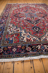 A low angle highlights the plush pile and turtle design border on a vintage Mehrivan carpet.