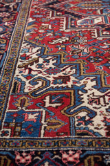 Angled detail of the vintage Mehrivan carpet's full pile and classic turtle design border.