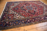 Vintage Mehrivan carpet at an angle, showing its quatrefoil medallion and classic turtle design border.