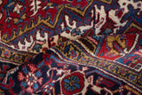 The dense, full pile and classic turtle design border of a folded vintage Mehrivan carpet.