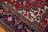 Reciprocating turtle and vine border design on a vintage Persian Mehrivan carpet corner.