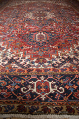 Hand-knotted Vintage Heriz carpet featuring ornate brick red, navy, ivory geometric border and fringe.